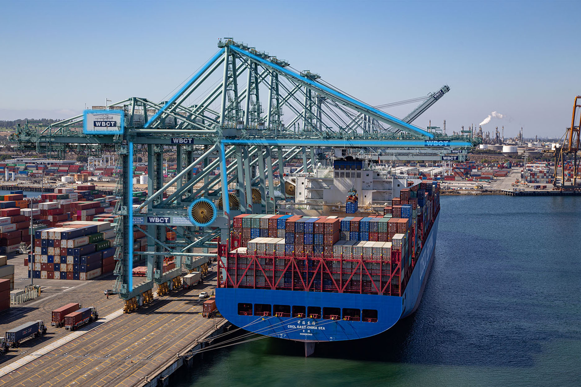 Electrified crane above a docked ship at a port terminal