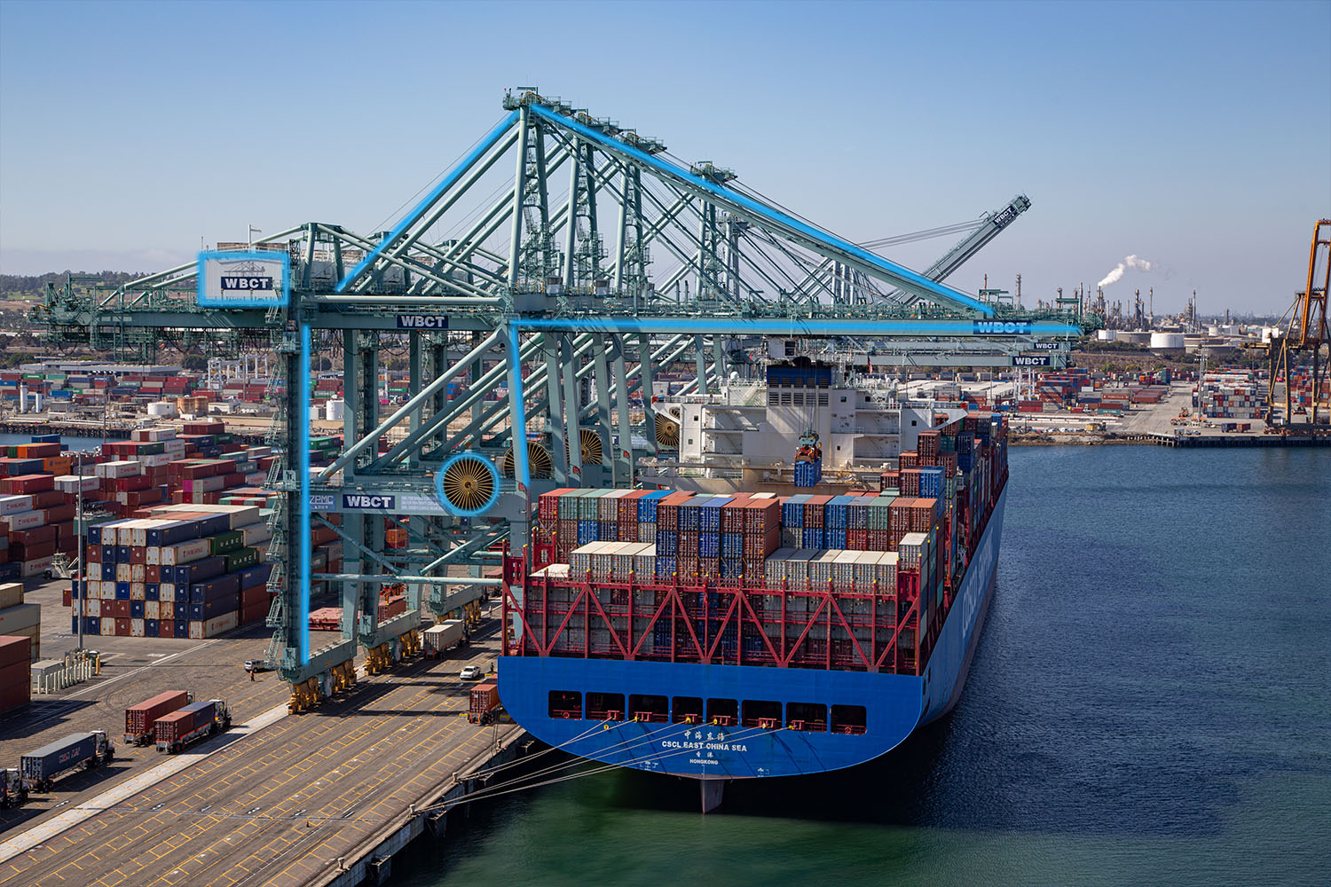 Electrified crane above a docked ship at a port terminal