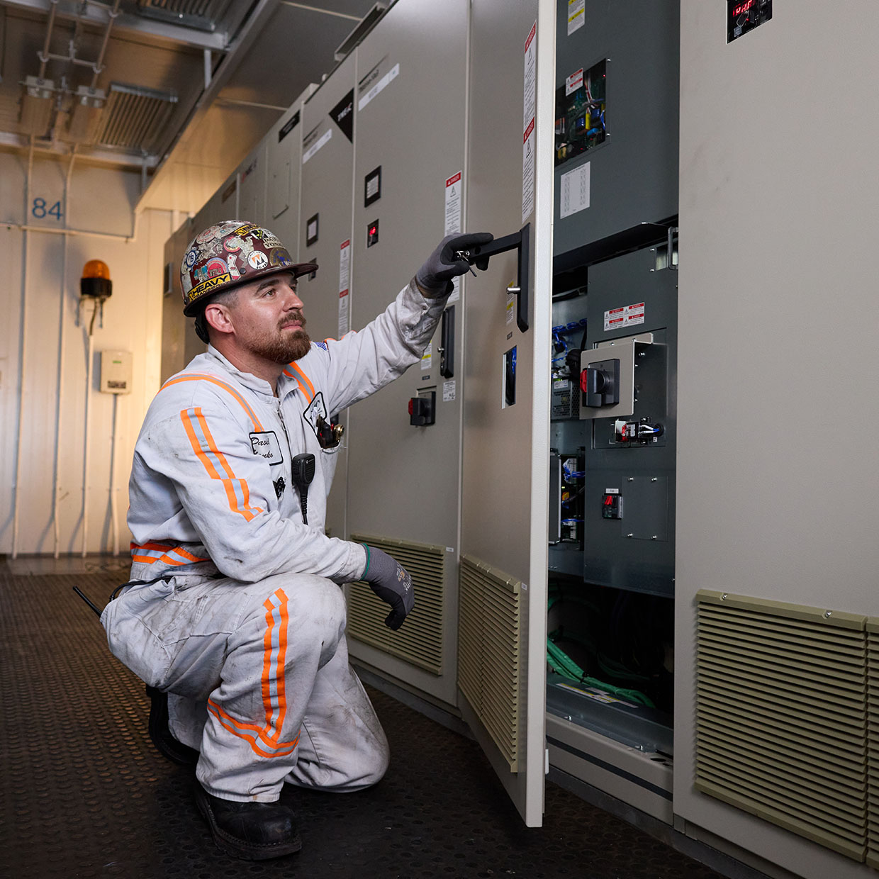 Technician inspects an electric control panel